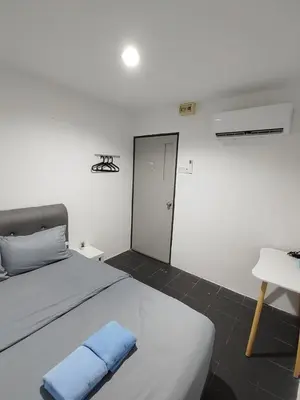 a bedroom with a bed with a blue towel on it at 184 GURNEY DRIVE PENANG in George Town