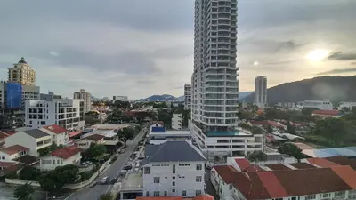 a city skyline with a tall building and buildings at Sunrise Gurney By IZ in George Town