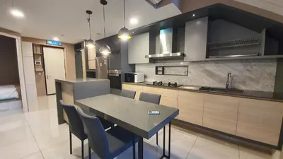 a kitchen with a table and chairs in a room at Sunrise Gurney By IZ in George Town