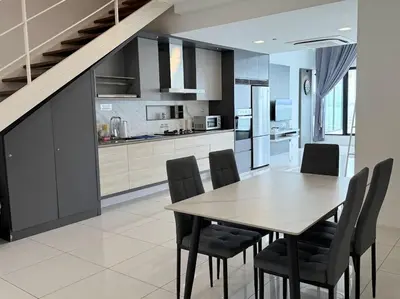 a kitchen and dining room with a table and chairs at Sunrise Gurney By IZ in George Town