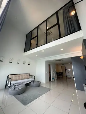 a large living room with a couch and a table at Sunrise Gurney By IZ in George Town
