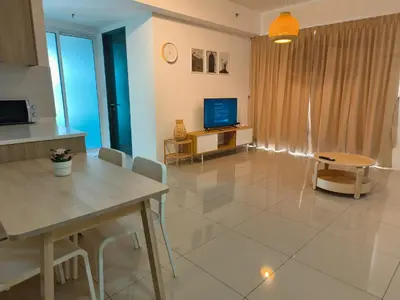 a living room with a table and a television at Beacon Executive Suites 2BR at Georgetown by WL in George Town