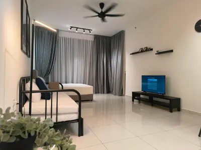 a living room with a bed and a tv in it at Beacon Executive Suites 2BR at Georgetown by WL in George Town