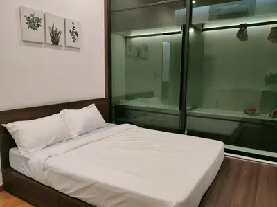a bedroom with a bed and a glass shower at Beacon Executive Suites 2BR at Georgetown by WL in George Town