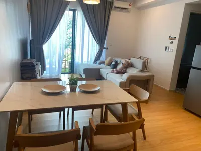 a living room with a table and a couch at Ipoh Tambun Lost World Sunway Onsen Suites Luna 2R2B 8paxs in Ipoh