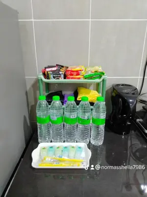 a group of bottles of water sitting on a counter at Olala Homestay Tanjung Rambutan Perak in Tanjung Rambutan