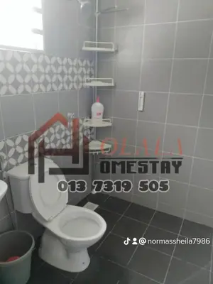 a bathroom with a white toilet in a room at Olala Homestay Tanjung Rambutan Perak in Tanjung Rambutan