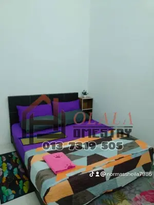 a bedroom with a large bed with purple pillows at Olala Homestay Tanjung Rambutan Perak in Tanjung Rambutan
