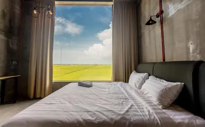 a bedroom with a bed with a large window at PADI Sentral @ Sekinchan in Sekincan