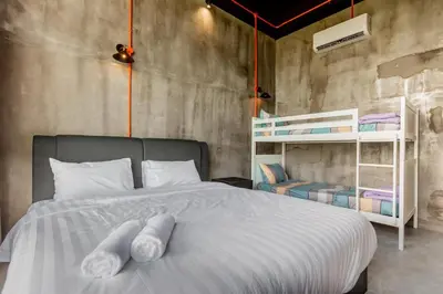 a bedroom with a bed and bunk beds in it at PADI Sentral @ Sekinchan in Sekincan