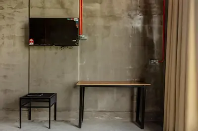 a table with a television on a wall at PADI Sentral @ Sekinchan in Sekincan