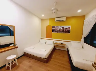 a bedroom with two beds and a yellow wall at Landed Home near Gurney and Georgetown for 18pax WL in George Town