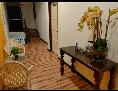 a room with a table with flowers on it at Landed Home near Gurney and Georgetown for 18pax WL in George Town