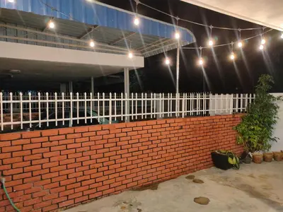 a brick wall with lights and a white fence at Landed Home near Gurney and Georgetown for 18pax WL in George Town