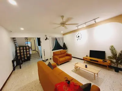a living room with a couch and a tv at Landed Home near Gurney and Georgetown for 18pax WL in George Town