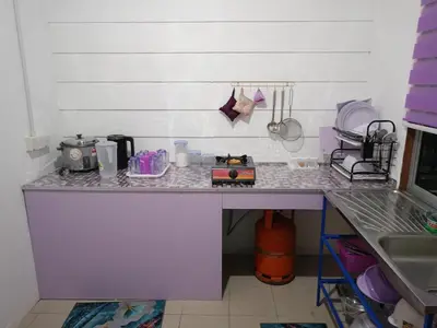 a kitchen with a counter with a sink and a counter at Purple Pool Villa in Kampong Batu Dua Puloh Tiga