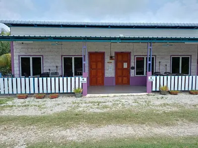 a house with purple doors and a white fence at Purple Pool Villa in Kampong Batu Dua Puloh Tiga