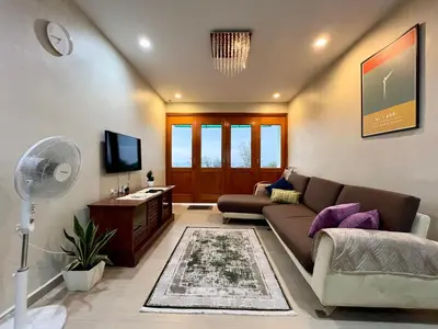 a living room with a couch and a tv at The Rockview Bayu Emas Penang Near Beach in Batu Ferringhi