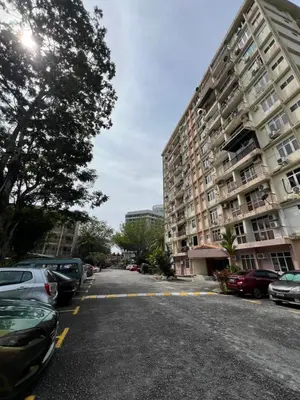 an empty street with cars parked in front of a building at The Rockview Bayu Emas Penang Near Beach in Batu Ferringhi