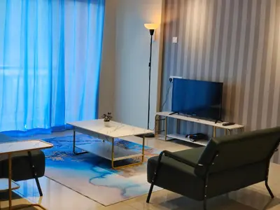 a living room with a tv and a table and a chair at Pavilionvillie M1T584 by irainbow in Simpang Pulai