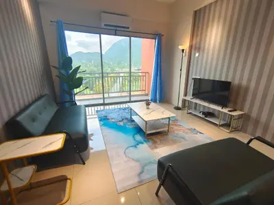 a living room with a couch and a table and a television at Pavilionvillie M1T584 by irainbow in Simpang Pulai