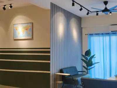 a waiting room with a blue chair and striped wall at Pavilionvillie M1T584 by irainbow in Simpang Pulai