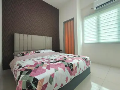a bedroom with a bed with a colorful comforter at Pavilionvillie M1T570 by irainbow in Ipoh