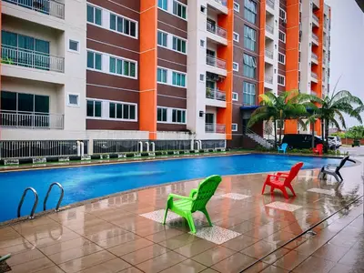 a swimming pool with chairs in front of a building at Pavilionvillie M1T570 by irainbow in Ipoh