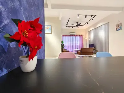 a vase with red flowers sitting on top of a table at Pavilionvillie M1T571 by irainbow in Ipoh