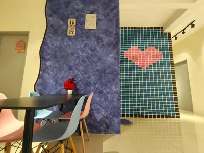 a dining room with a table and hearts on the wall at Pavilionvillie M1T571 by irainbow in Ipoh