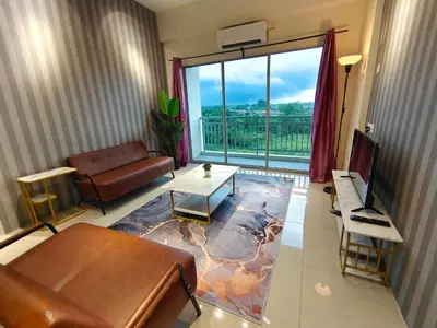 a living room with a couch and a large window at Pavilionvillie M1T571 by irainbow in Ipoh