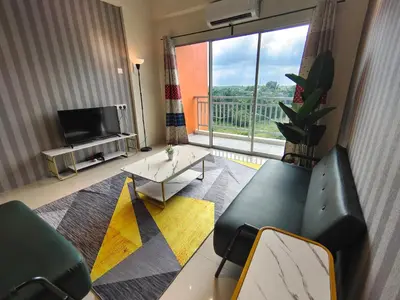 a living room with a couch and a table and a tv at Pavilionvillie M1T572 by irainbow in Ipoh