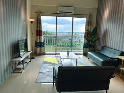 a living room with a couch and a large window at Pavilionvillie M1T572 by irainbow in Ipoh