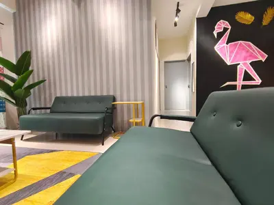 a room with a couch and a pink flamingo on the wall at Pavilionvillie M1T572 by irainbow in Ipoh