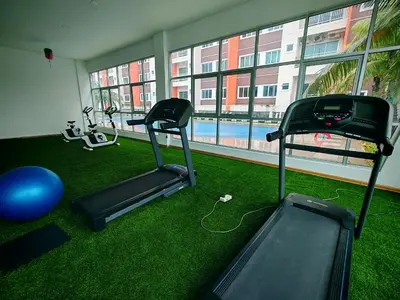 a gym with two exercise bikes and a swimming pool at Pavilionvillie M1T572 by irainbow in Ipoh