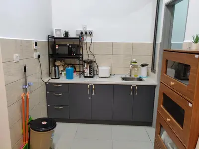 a small kitchen with a sink and a microwave at Mars Homestay in Kea Farm Brinchang in Brinchang