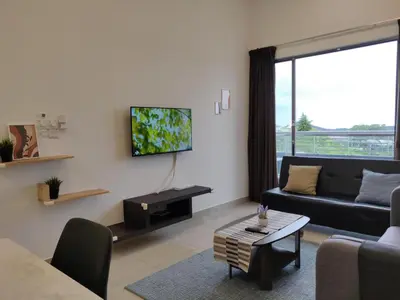 a living room with a couch and a tv on a wall at Mars Homestay in Kea Farm Brinchang in Brinchang