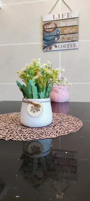 a vase filled with flowers sitting on top of a table at H&W Sunway Onsen Suite 4-7pax near Lost World of Tambun Ipoh in Ipoh