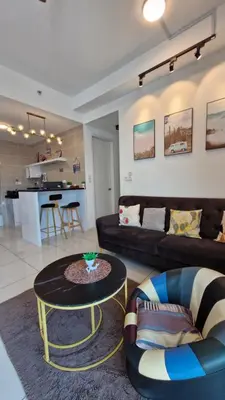 a living room with a couch and a table at H&W Sunway Onsen Suite 4-7pax near Lost World of Tambun Ipoh in Ipoh