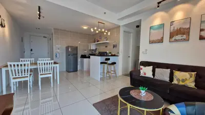 a living room and kitchen with a couch and a table at H&W Sunway Onsen Suite 4-7pax near Lost World of Tambun Ipoh in Ipoh
