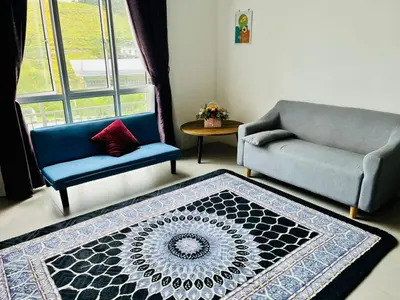 a living room with two chairs and a rug at 1 Bedroom Apartment @ Golden Hills Cameron Highlands Pasar Malam in Cameron Highlands