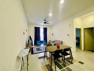 a living room with a dining room table and chairs at 1 Bedroom Apartment @ Golden Hills Cameron Highlands Pasar Malam in Cameron Highlands