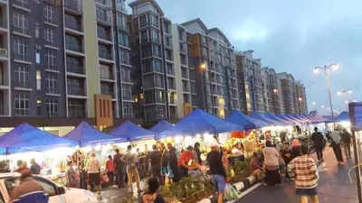 a group of people standing around a market with blue tents at 1 Bedroom Apartment @ Golden Hills Cameron Highlands Pasar Malam in Cameron Highlands