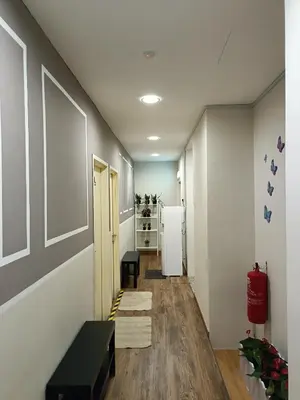 a hallway with a refrigerator and a table in a room at Only You Boutique Hotel Centrum Cameron Highlands in Brinchang