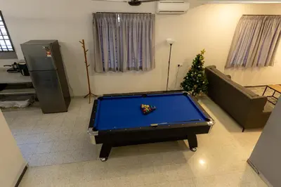 a living room with a pool table and a christmas tree at GEORGETOWN 18Px 5R4B V KTV & JACCUZI SPA & POOL TABLE NEAR USM & LAM WAH EE HOSPITAL & HAN CHIANG HIGH SCHOOL - kids pool no more in Gelugor