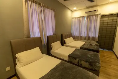 a room with two beds and a couch and a window at GEORGETOWN 18Px 5R4B V KTV & JACCUZI SPA & POOL TABLE NEAR USM & LAM WAH EE HOSPITAL & HAN CHIANG HIGH SCHOOL - kids pool no more in Gelugor