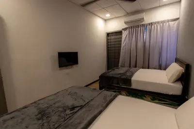 a bedroom with two beds and a tv and a window at GEORGETOWN 18Px 5R4B V KTV & JACCUZI SPA & POOL TABLE NEAR USM & LAM WAH EE HOSPITAL & HAN CHIANG HIGH SCHOOL - kids pool no more in Gelugor