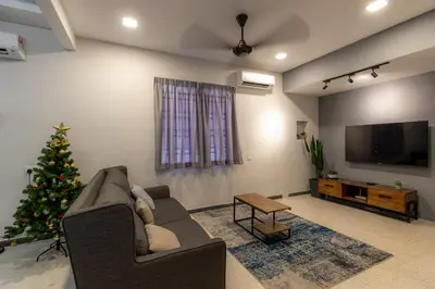 a living room with a christmas tree and a couch at GEORGETOWN 18Px 5R4B V KTV & JACCUZI SPA & POOL TABLE NEAR USM & LAM WAH EE HOSPITAL & HAN CHIANG HIGH SCHOOL - kids pool no more in Gelugor