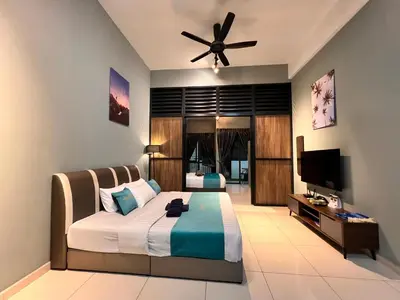 a bedroom with a bed and a ceiling fan at BLUE JADE STUDIOS in Tanah Rata