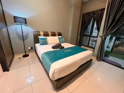 a bedroom with a bed with a lamp and a window at BLUE JADE STUDIOS in Tanah Rata